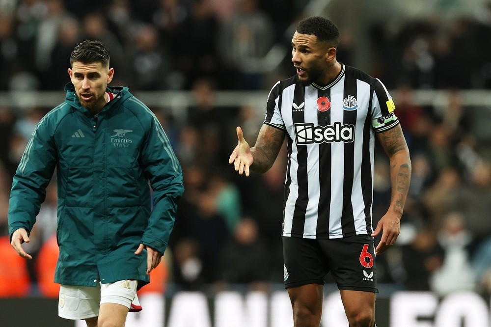 NEWCASTLE UPON TYNE, ENGLAND: Jamaal Lascelles of Newcastle United clashes with Jorginho of Arsenal following the Premier League match between Newc...