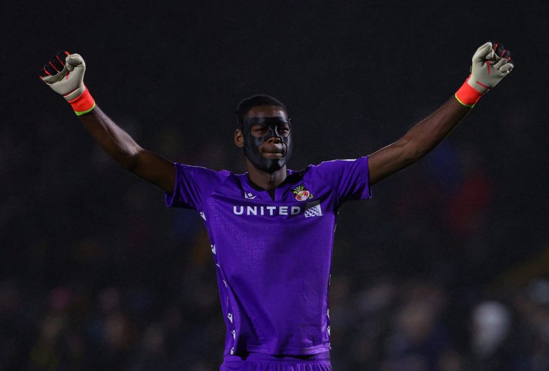 SUTTON, ENGLAND - FEBRUARY 13: Arthur Okonkwo of Wrexham celebrates his side's first goal whilst wearing a protective face mask during the Sky Bet ...