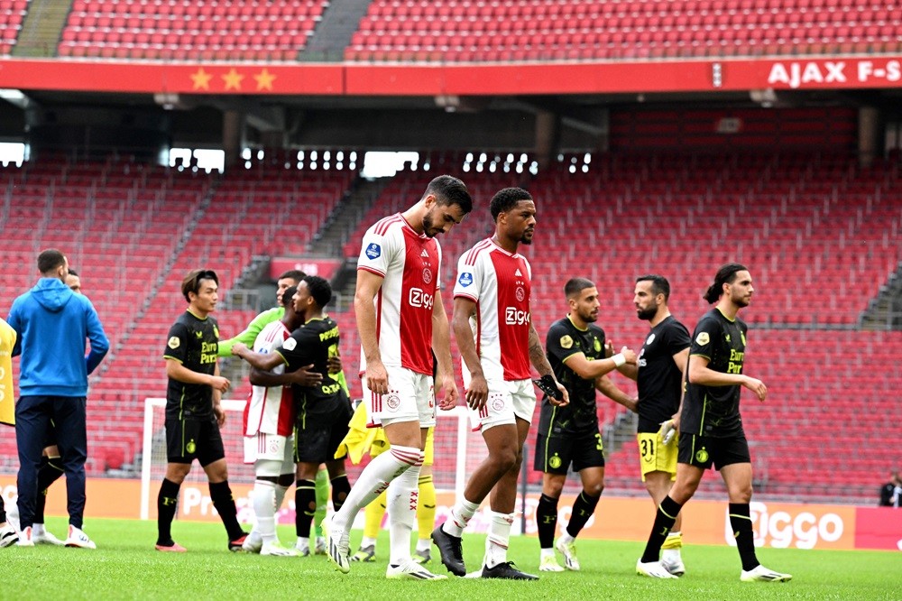 Ajax's Josip Sutalo (L) and Chuba Akpom leave the pitch after losing the Dutch Eredivisie football match between Ajax Amsterdam and Feyenoord Rotterdam at the Johan Cruijff ArenA in Amsterdam on September 27, 2023. (Photo by OLAF KRAAK/ANP/AFP via Getty Images)