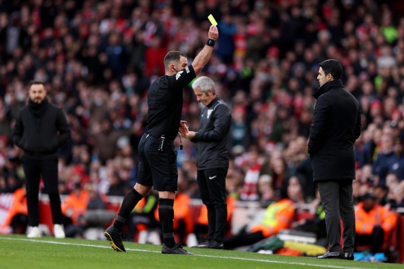 LONDON, ENGLAND - DECEMBER 17: Referee Tim Robinson shows a yellow card to Mikel Arteta, Manager of Arsenal, during the Premier League match between Arsenal FC and Brighton & Hove Albion at Emirates Stadium on December 17, 2023 in London, England. (Photo by Richard Heathcote/Getty Images)
