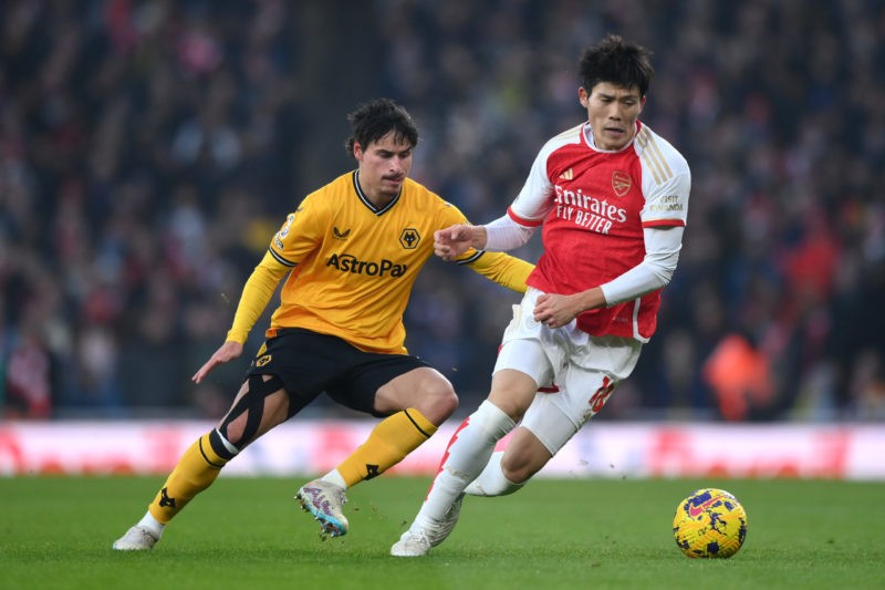 LONDON, ENGLAND - DECEMBER 02: Takehiro Tomiyasu of Arsenal takes on Hugo Bueno of Wolverhampton Wanderers during the Premier League match between ...