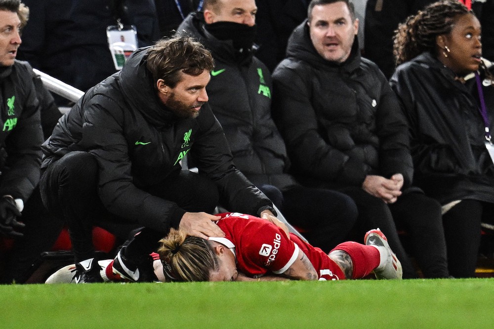 Liverpool 27yo's Instagram post highlights absurd fan abuse 2 Liverpool's Kostas Tsimikas (R) injured following a collision reacts as he lays on the pitch during the English Premier League football match between Liverpool and Arsenal at Anfield in Liverpool, north west England on December 23, 2023. (Photo by Paul ELLIS / AFP)
