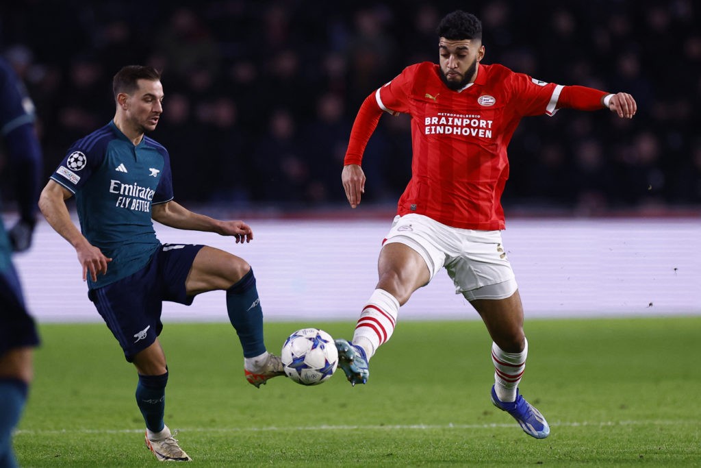 Transfer talks underway for Arsenal defender to leave 4 PSV Eindhoven's Belgian midfielder #24 Ismael Saibari (R) and Arsenal's Portuguese defender #17 Cedric fight for the ball during a UEFA Champions League group B football match between PSV Eindhoven and Arsenal FC at the Philips Stadium in Eindhoven, on December 12, 2023. (Photo by KENZO TRIBOUILLARD/AFP via Getty Images)