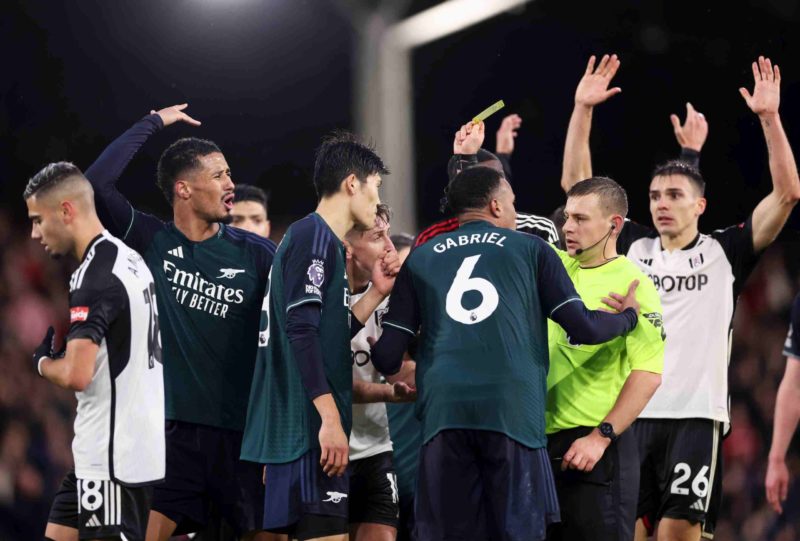 Arsenal are 'flat and tired' says pundit after Fulham defeat 3 LONDON, ENGLAND - DECEMBER 31: Match Referee Josh Smith shows a yellow card to William Saliba of Arsenal during the Premier League match between Fulham FC and Arsenal FC at Craven Cottage on December 31, 2023 in London, England. (Photo by Alex Pantling/Getty Images)