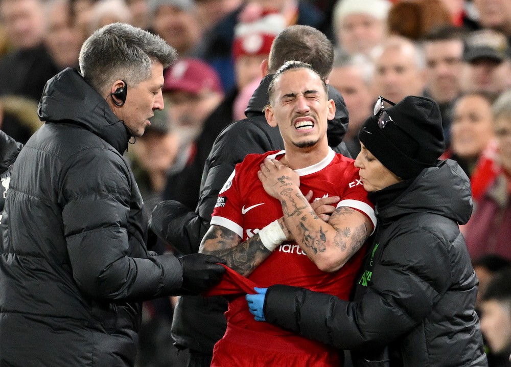 LIVERPOOL, ENGLAND: Kostas Tsimikas of Liverpool receives medical treatment during the Premier League match between Liverpool FC and Arsenal FC at ...