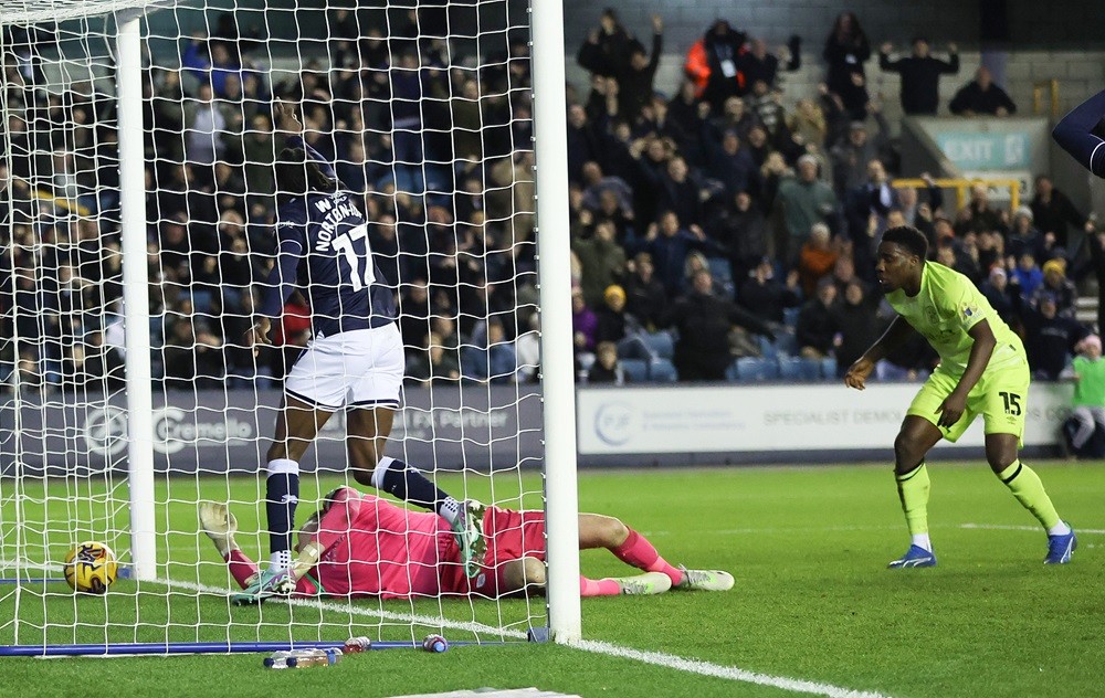 Teenage Arsenal defender scores 2nd Championship goal 2 LONDON, ENGLAND: Brooke Norton-Cuffy of Millwall scores to make it 1-0 against Lee Nicholls of Huddersfield Town during the Sky Bet Championship match between Millwall and Huddersfield Town at The Den on December 16, 2023. (Photo by Richard Pelham/Getty Images)