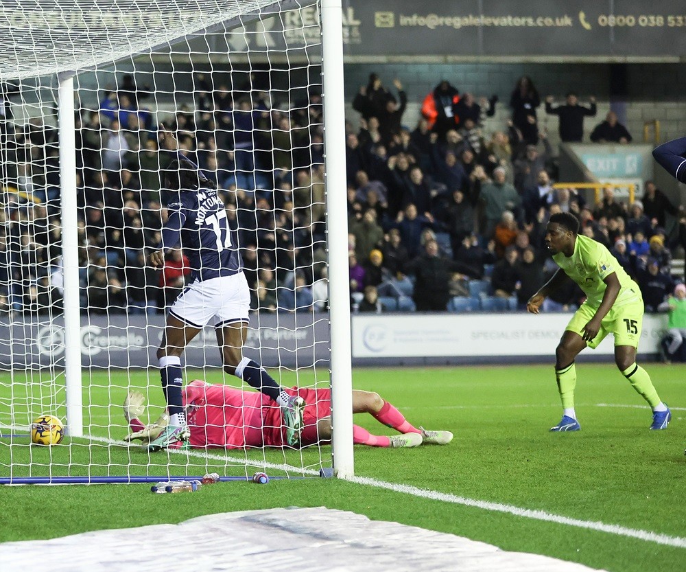 LONDON, ENGLAND: Brooke Norton-Cuffy of Millwall scores to make it 1-0 against Lee Nicholls of Huddersfield Town during the Sky Bet Championship ma...