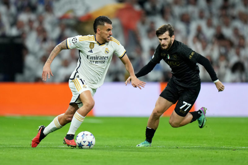 MADRID, SPAIN - NOVEMBER 29: Dani Ceballos of Real Madrid runs with the ball whilst under pressure from Khvicha Kvaratskhelia of SSC Napoli during the UEFA Champions League match between Real Madrid and SSC Napoli at Estadio Santiago Bernabeu on November 29, 2023 in Madrid, Spain. (Photo by Angel Martinez/Getty Images)
