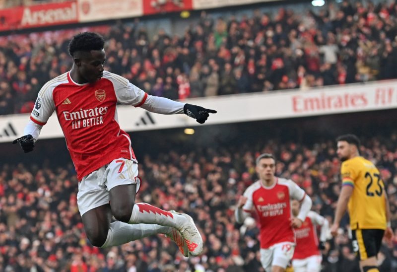 TOPSHOT - Arsenal's English midfielder #07 Bukayo Saka celebrates scoring the opening goal during the English Premier League football match between...