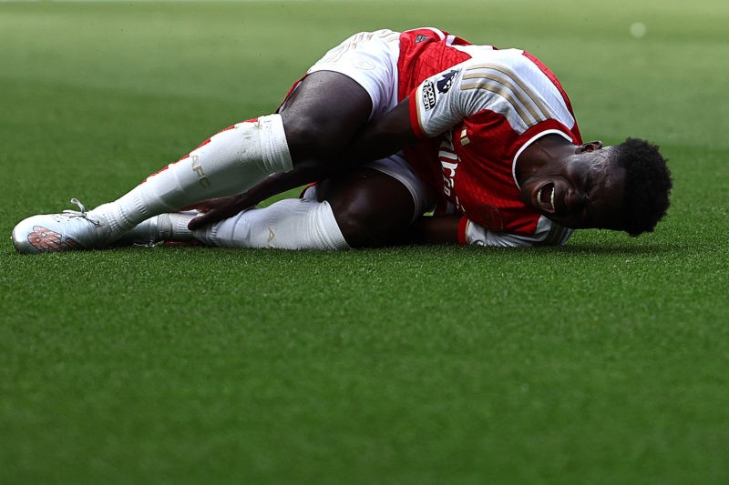 Arsenal's English midfielder #07 Bukayo Saka reacts in pain after a foul during the English Premier League football match between Arsenal and Fulham at the Emirates Stadium in London on August 26, 2023. (Photo by HENRY NICHOLLS/AFP via Getty Images)