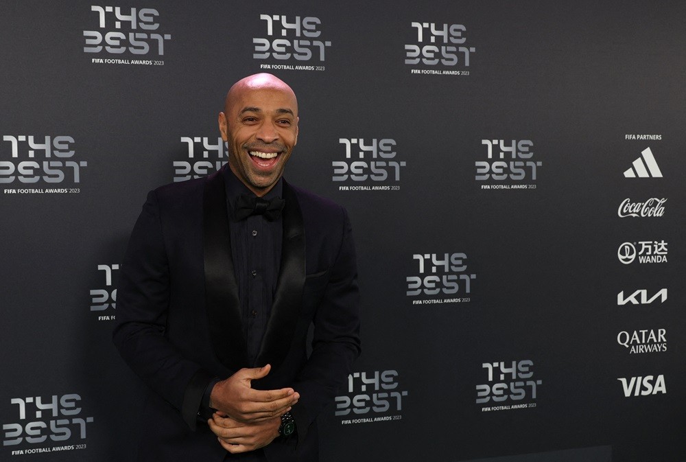 Former France International Thierry Henry smiles upon arrival to attend the Best FIFA Football Awards 2023 ceremony in London on January 15, 2024. ...