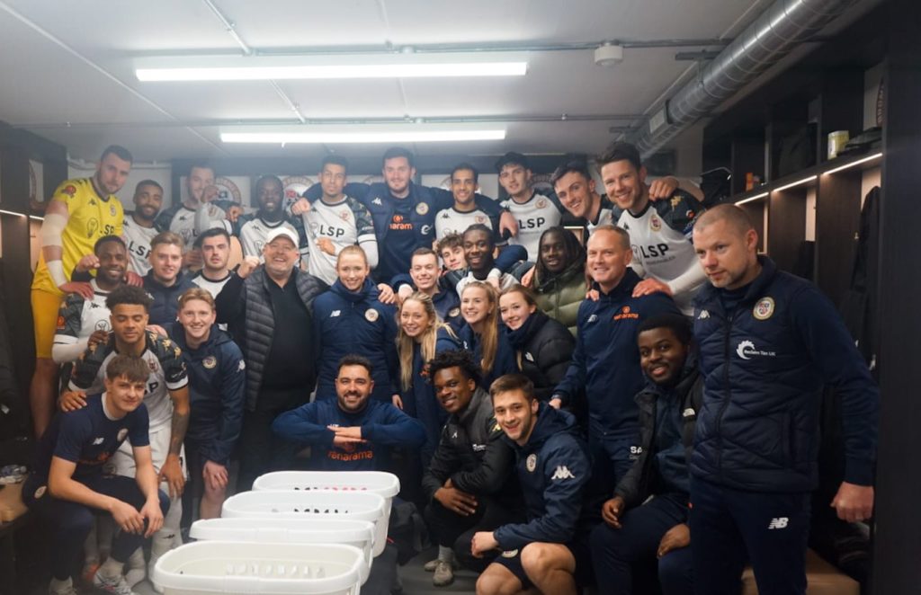 Alex Kirk (top row, 2nd-right) celebrates Bromley's win over Chesterfield (Photo via Bromley FC)