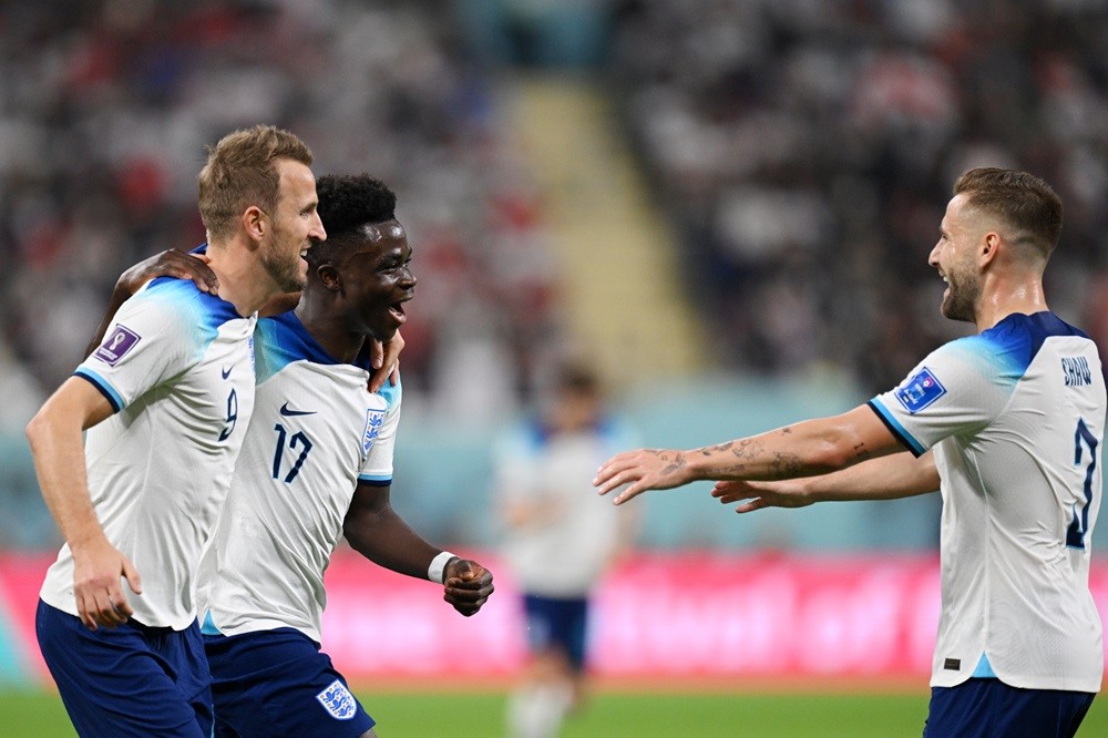 3 Arsenal players included in England squad 2 DOHA, QATAR: Bukayo Saka (C) of England celebrates scoring his team's fourth goal with their teammates Harry Kane (L) and Luke Shaw (R) during the FIFA World Cup Qatar 2022 Group B match between England and IR Iran at Khalifa International Stadium on November 21, 2022. (Photo by Matthias Hangst/Getty Images)