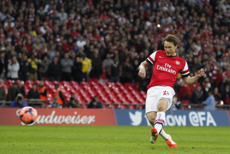Arsenal's Swedish midfielder Kim Kallstrom scores his penalty during the penalty shootout during the English FA Cup Semi-final match between Wigan ...
