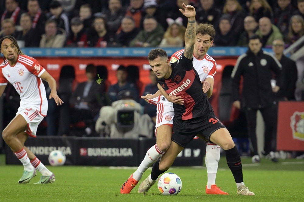 Former Gunner embarrasses ex-Spurs duo in 3-0 title race thrashing 4 Bayer Leverkusen's Granit Xhaka (C) and Bayern Munich's Leon Goretzka (R) vie for the ball during the German first division Bundesliga football match between Bayer 04 Leverkusen and FC Bayern Munich in Leverkusen, western Germany on February 10, 2024. (Photo by SASCHA SCHUERMANN/AFP via Getty Images)