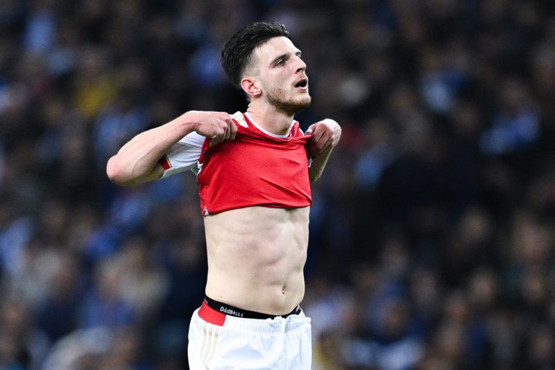 PORTO, PORTUGAL - FEBRUARY 21: Declan Rice of Arsenal reacts, as he wipes his face with his shirt, during the UEFA Champions League 2023/24 round o...