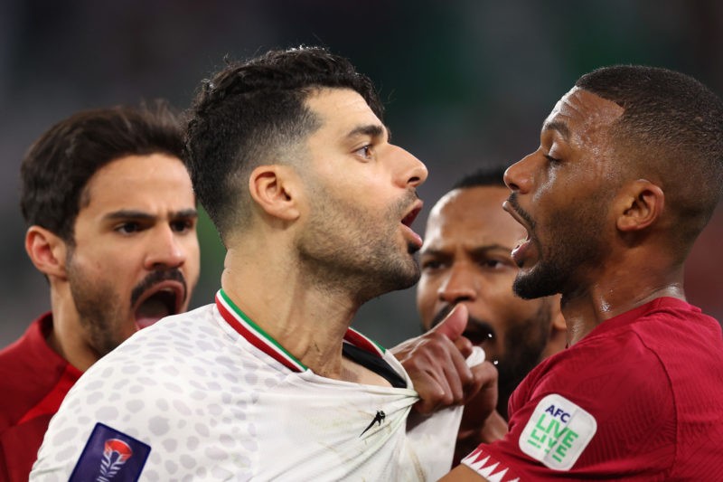 DOHA, QATAR - FEBRUARY 07: Mehdi Taremi of Iran and Abdulaziz Hatem of Qatar clash following the AFC Asian Cup Semi Final match between Iran and Qa...