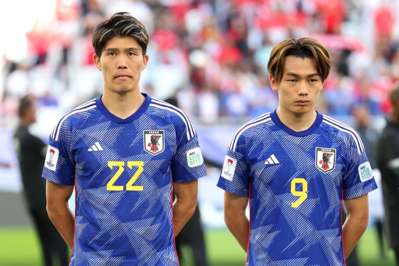 DOHA, QATAR - JANUARY 24: Takehiro Tomiyasu and Ayase Ueda of Japan line up prior to the AFC Asian Cup Group D match between Japan and Indonesia at...