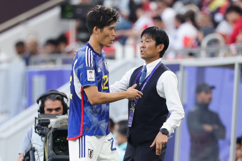 DOHA, QATAR - JANUARY 24: Hajime Moriyasu, Head Coach of Japan talk with Takehiro Tomiyasu during the AFC Asian Cup Group D match between Japan and...