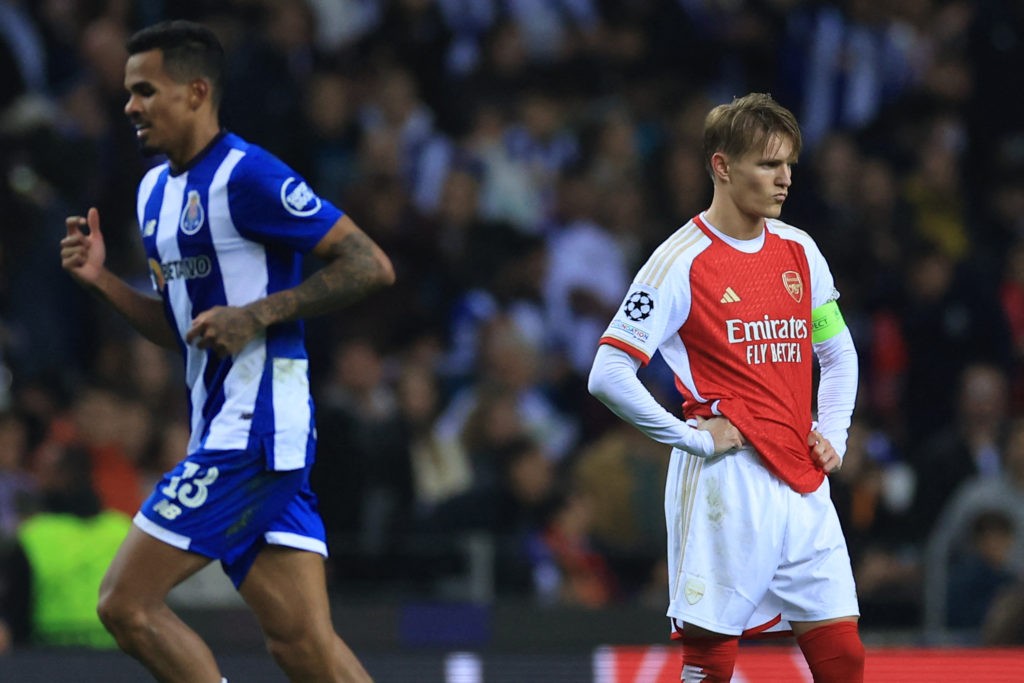 TOPSHOT - Arsenal's Norwegian midfielder #08 Martin Odegaard (R) reacts next to FC Porto's Brazilian midfielder #13 Wenderson Galeno during the UEFA Champions League last 16 first leg football match between FC Porto and Arsenal FC at the Dragao stadium in Porto on February 21, 2024. (Photo by PATRICIA DE MELO MOREIRA/AFP via Getty Images)