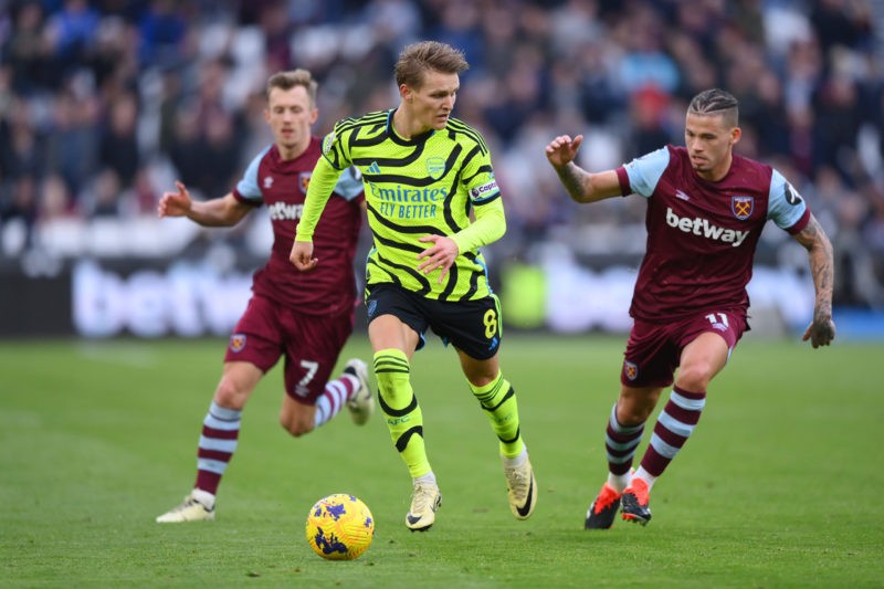 LONDON, ENGLAND - FEBRUARY 11: Martin Odegaard of Arsenal runs with the ball from Kalvin Phillips of West Ham United during the Premier League matc...