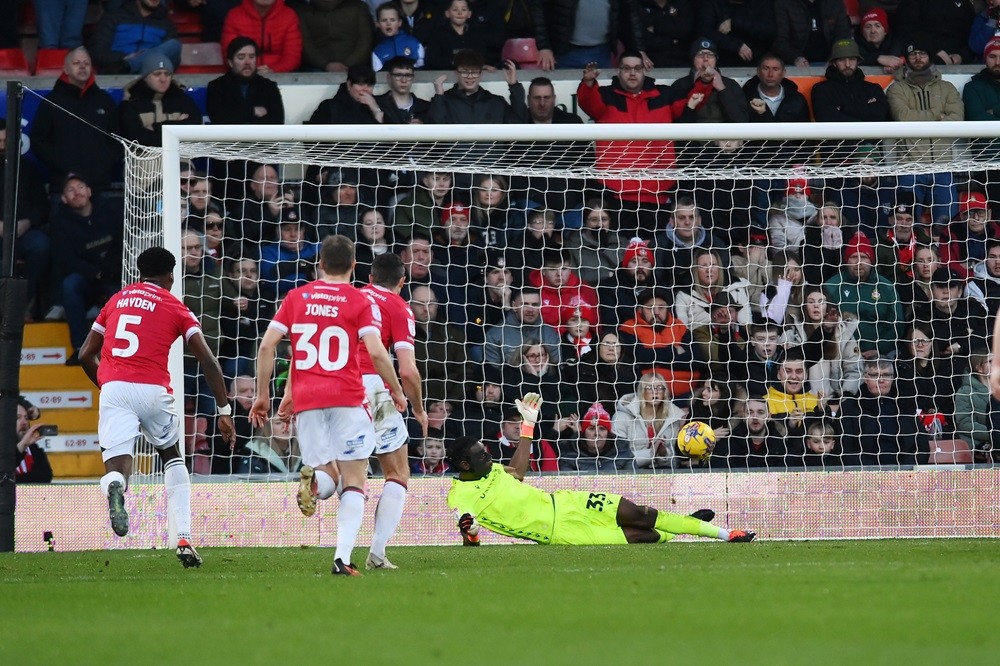 WREXHAM, WALES: Arthur Okonkwo of Wrexham saves a penalty from Andy Cook of Bradford City during the Sky Bet League Two match between Wrexham and B...