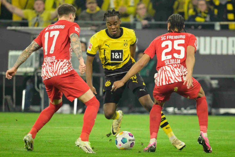 Dortmund's English forward #43 Jamie Bynoe-Gittens (C) vies with Freiburg's German defender #17 Lukas Kuebler (L) and Freiburg's French defender #25 Kiliann Sildillia during the German first division Bundesliga football match between BVB Borussia Dortmund and SC Freiburg in Dortmund, western Germany on February 9, 2024. (Photo by SASCHA SCHUERMANN/AFP via Getty Images)