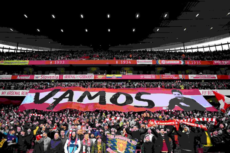 Arsenal fans show their support and hold up a banner reading "Vamos" prior to the Premier League match between Arsenal FC and Brentford FC at Emira...