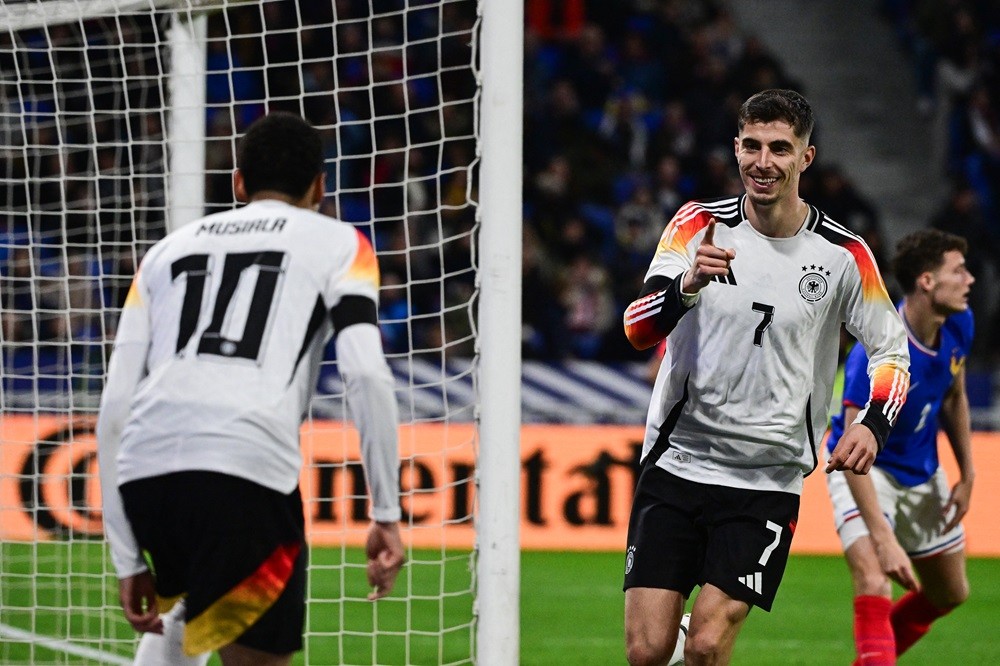 Germany's Kai Havertz (R) celebrates after scoring Germany's second goal with Jamal Musiala (L) during the friendly football match between France a...