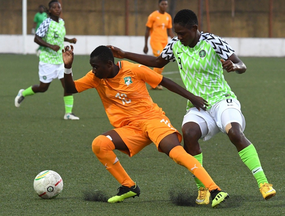 Nigeria's Chidinma Okeke (R) vies with Ivory Coast's Rosemonde Kouassi (L) during the West African Football Union (WAFU) women final football match...