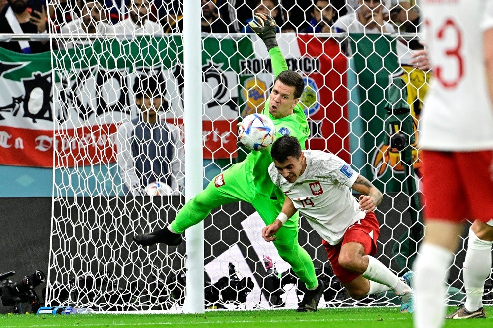 Arsenal Euro 2024 roundup: Midfielder sets new tournament high 5 Poland's Wojciech Szczesny (L) punches the ball ahead of Jakub Kiwior during the Qatar 2022 World Cup round of 16 football match between France and Poland at the Al-Thumama Stadium in Doha on December 4, 2022. (Photo by JAVIER SORIANO/AFP via Getty Images)