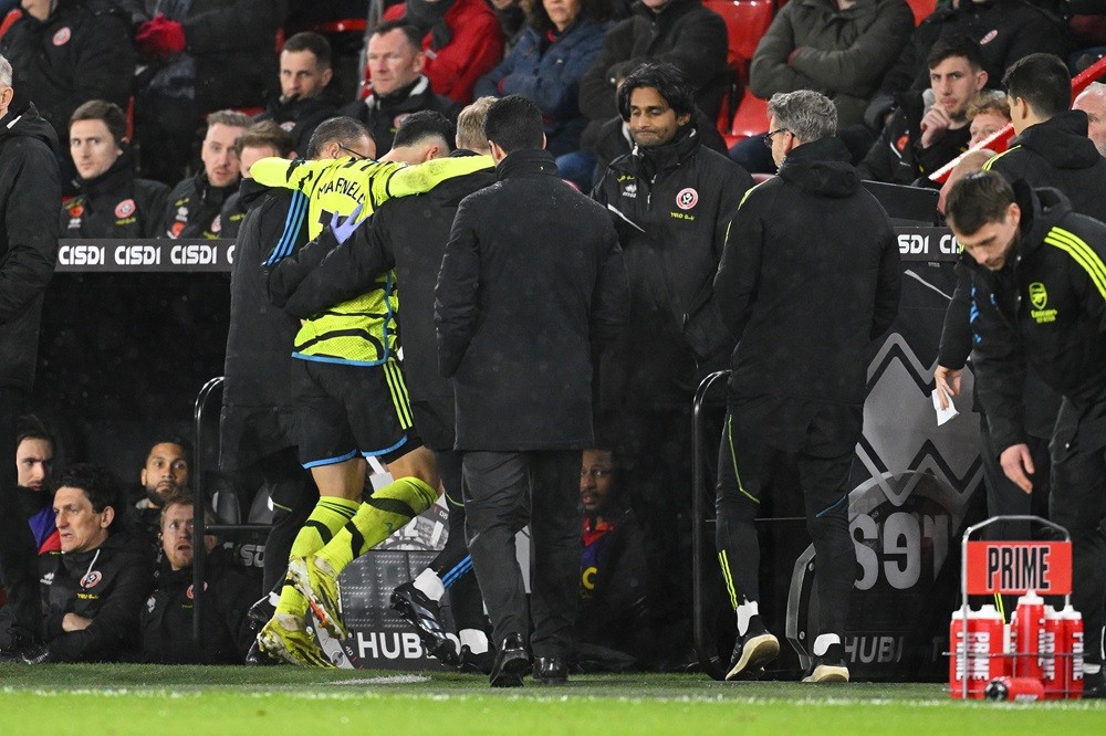 SHEFFIELD, ENGLAND: Gabriel Martinelli of Arsenal is helped off the pitch by medical staff after an injury during the Premier League match between ...