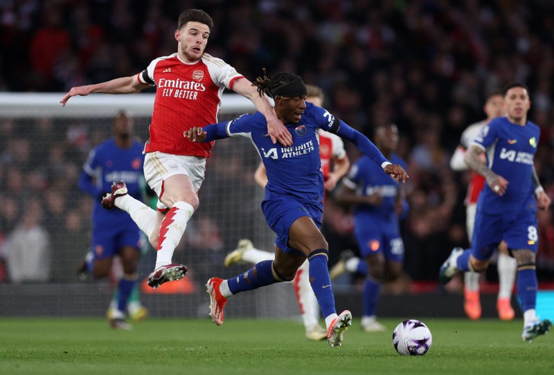LONDON, ENGLAND - APRIL 23: Declan Rice of Arsenal battles for possession with Noni Madueke of Chelsea during the Premier League match between Arse...