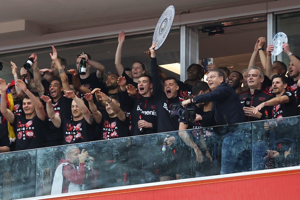LEVERKUSEN, GERMANY: Granit Xhaka of Bayer Leverkusen celebrates with a replica trophy alongside players after their team's victory and winning the Bundesliga title for the first time in their history after the Bundesliga match between Bayer 04 Leverkusen and SV Werder Bremen at BayArena on April 14, 2024. (Photo by Lars Baron/Getty Images)