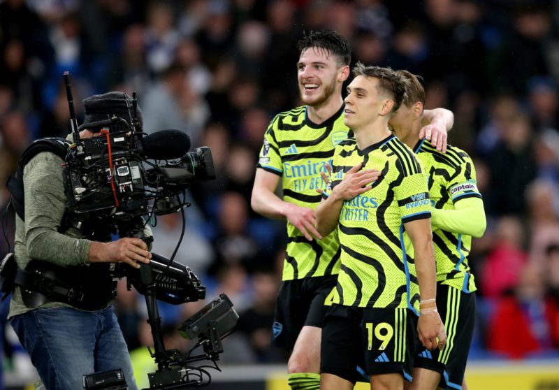 BRIGHTON, ENGLAND - APRIL 06: Leandro Trossard of Arsenal celebrates scoring his team's third goal with teammates Declan Rice and Martin Odegaard during the Premier League match between Brighton & Hove Albion and Arsenal FC at American Express Community Stadium on April 06, 2024 in Brighton, England.(Photo by Steve Bardens/Getty Images)