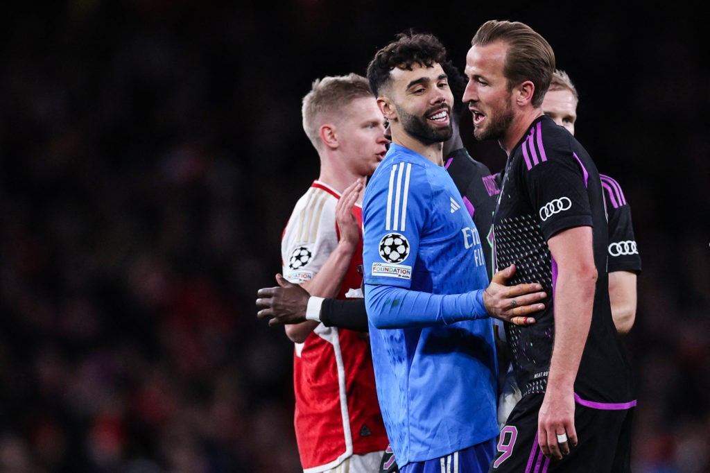 Arsenal's Spanish goalkeeper #22 David Raya (L) and Bayern Munich's English striker #09 Harry Kane congratulate each other at the end of the UEFA Champions League quarter final first-leg football match between Arsenal and Bayern Munich at the Arsenal Stadium, in north London, on April 9, 2024. Arsenal and Bayern Munich equalised 2 -2. (Photo by ADRIAN DENNIS/AFP via Getty Images)