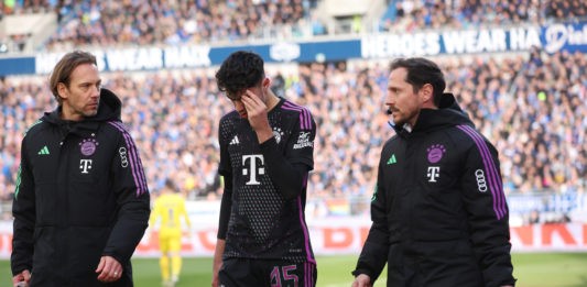 DARMSTADT, GERMANY - MARCH 16: Aleksandar Pavlovic of Bayern Munich holds an ice cube above his eye during the Bundesliga match between SV Darmstadt 98 and FC Bayern München at Merck-Stadion am Böllenfalltor on March 16, 2024 in Darmstadt, Germany. (Photo by Alex Grimm/Getty Images)