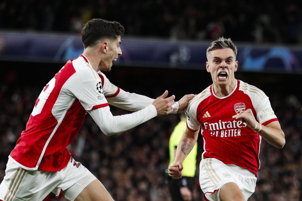 TOPSHOT - Arsenal's Belgian midfielder #19 Leandro Trossard (R) celebrates after scoring his team second goal during the UEFA Champions League quarter final first-leg football match between Arsenal and Bayern Munich at the Arsenal Stadium, in north London, on April 9, 2024. (Photo by IAN KINGTON/IKIMAGES/AFP via Getty Images)