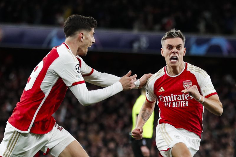 TOPSHOT - Arsenal's Belgian midfielder #19 Leandro Trossard (R) celebrates after scoring his team second goal during the UEFA Champions League quarter final first-leg football match between Arsenal and Bayern Munich at the Arsenal Stadium, in north London, on April 9, 2024.  (Photo by IAN KINGTON/IKIMAGES/AFP via Getty Images)