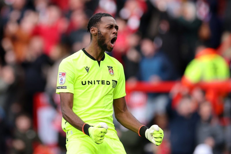 WREXHAM, WALES - MARCH 29: Arthur Okonkwo of Wrexham celebrates after Paul Mullin of Wrexham (not pictured) scores his team's first goal during the...