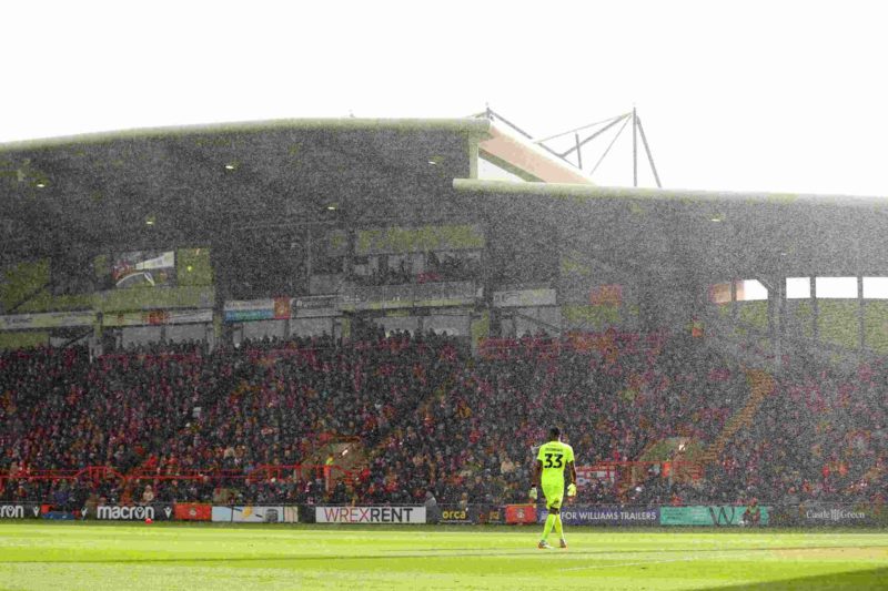 WREXHAM, WALES - MARCH 29: Arthur Okonkwo of Wrexham looks on in the rain during the Sky Bet League Two match between Wrexham and Mansfield Town at...