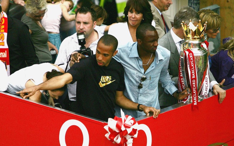 Arsenal Premier League title parade details released 2 LONDON - MAY 16: Thierry Henry (L) and Patrick Vieira are seen at the front of the bus outside the Islington Town Hall during the Arsenal Football Club victory parade to show the League Champions with their FA Barclaycard Premiership Trophy on May 16, 2004 in Highbury, London. (Photo by Clive Mason/Getty Images)