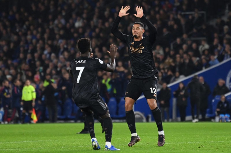 Arsenal's French defender William Saliba (R) and Arsenal's English midfielder Bukayo Saka (L) celebrate their second goal during the English Premier League football match between Brighton and Hove Albion and Arsenal at the American Express Community Stadium in Brighton, southern England on December 31, 2022. (Photo by GLYN KIRK/AFP via Getty Images)
