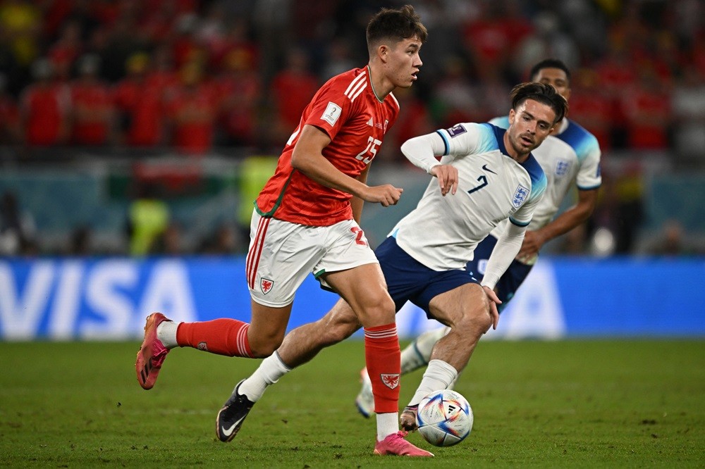 Wales' Rubin Colwill is challenged by England's Jack Grealish during the Qatar 2022 World Cup Group B football match between Wales and England at t...