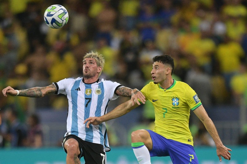 Argentina's midfielder Rodrigo De Paul (L) and Brazil's forward Gabriel Martinelli fight for the ball during the 2026 FIFA World Cup South American...