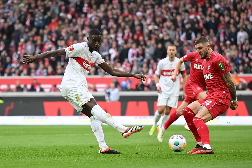 STUTTGART, GERMANY: Serhou Guirassy of VfB Stuttgart challenges Jeff Chabot of 1.FC Köln during the Bundesliga match between VfB Stuttgart and 1. F...