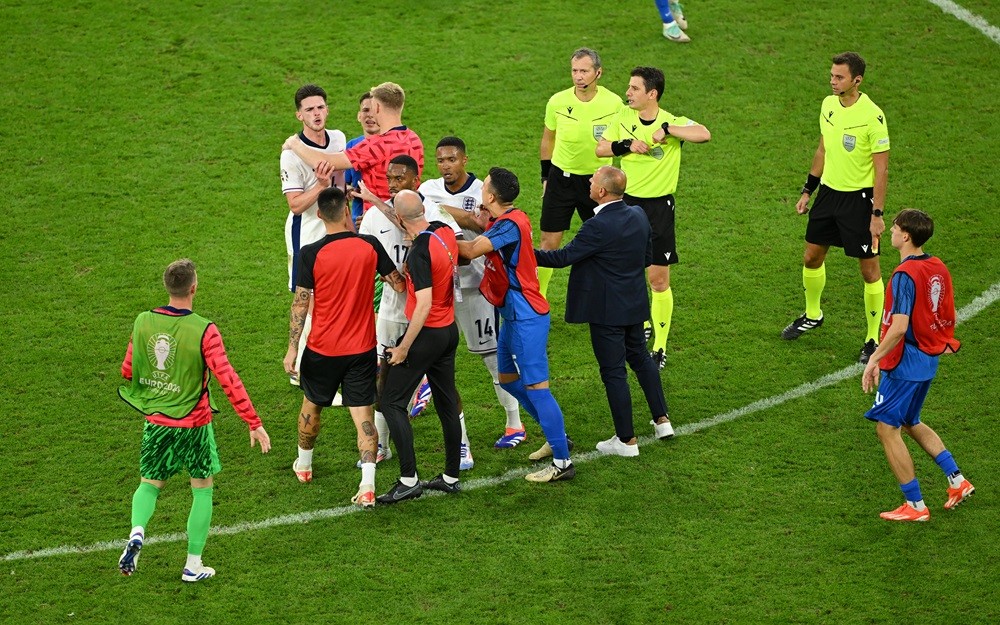 GELSENKIRCHEN, GERMANY: Declan Rice of England clashes with Francesco Calzona, Head Coach of Slovakia, as he is held back by teammates after the UE...