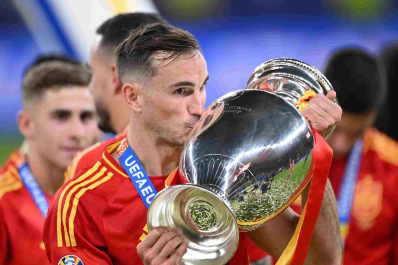 Spain's midfielder #08 Fabian Ruiz celebrates with the trophy after winning the UEFA Euro 2024 final football match between Spain and England at th...