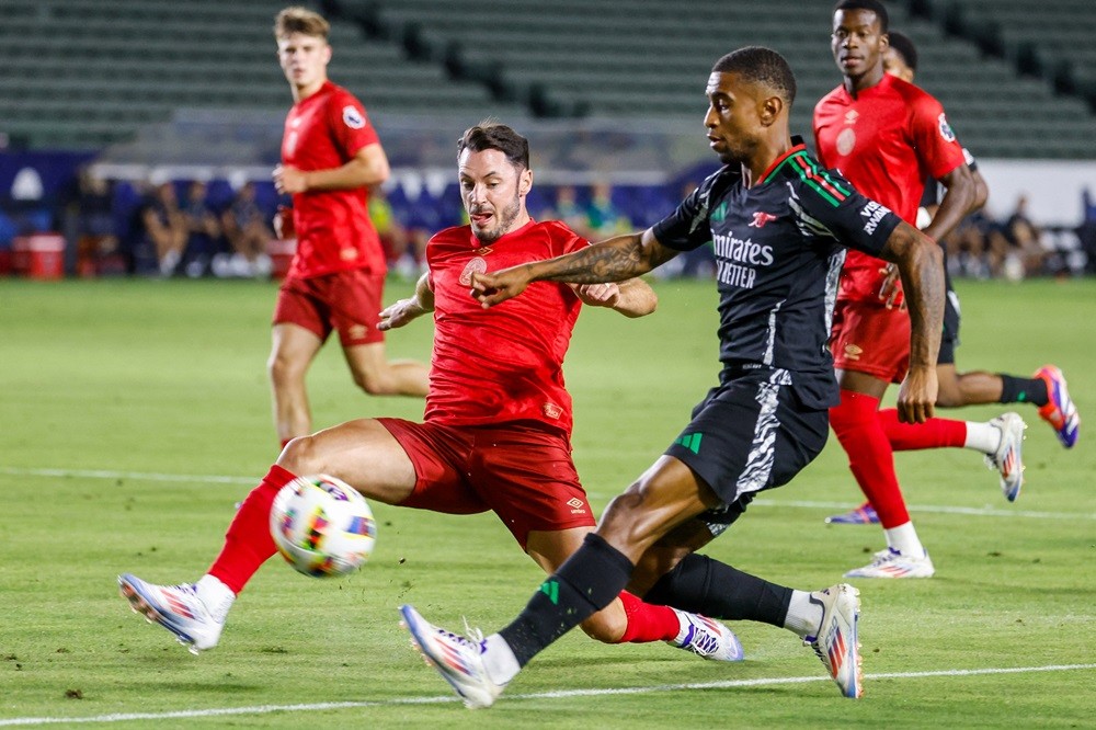 Bournemouth's Adam Smith (L) fights for the ball with Arsenal's Reiss Nelson during a pre-season friendly football match between Arsenal FC and AFC...