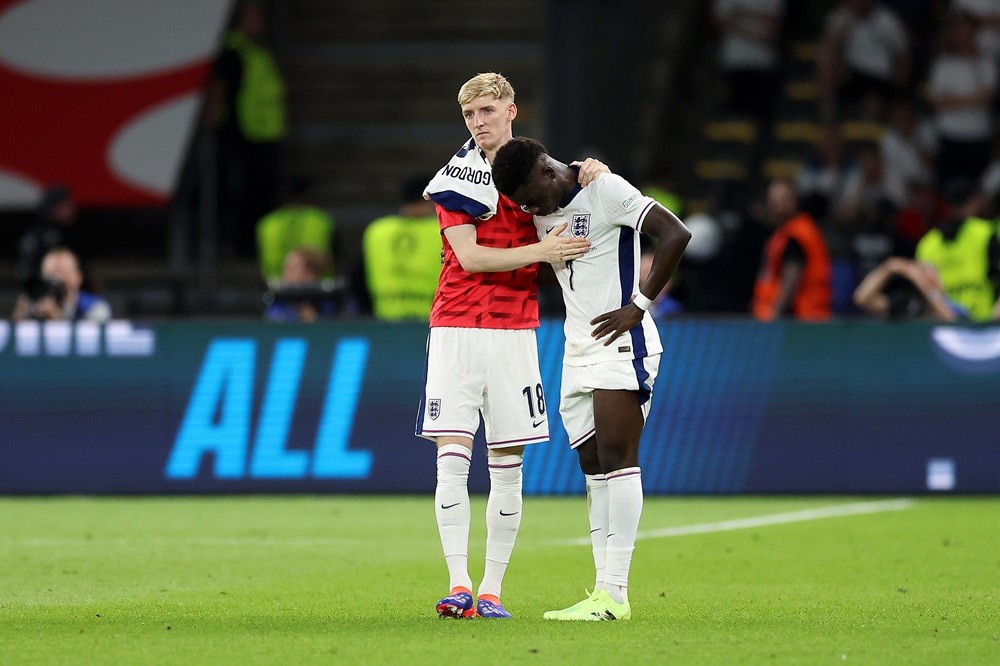 BERLIN, GERMANY: Bukayo Saka of England is consoled by Anthony Gordon after defeat during the UEFA EURO 2024 final match between Spain and England ...